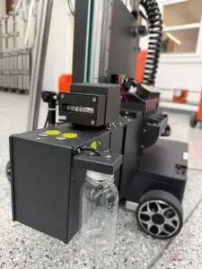 The Wall Printer PumpBox ink management system featuring Clean and Pump controls, built-in filtration, and glass ink reservoir for consistent UV ink delivery during wall and floor printing