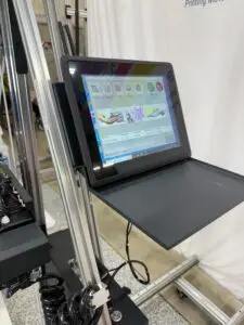 Detachable 12.1-inch Windows touchscreen on the WP-UV-PRO wall printer showing print management software with import, preview, and print controls
