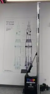 WP-UV-PRO wall printer with extended rail system printing a large-format rocket blueprint mural on a white wall — demonstrating full-height commercial printing capability