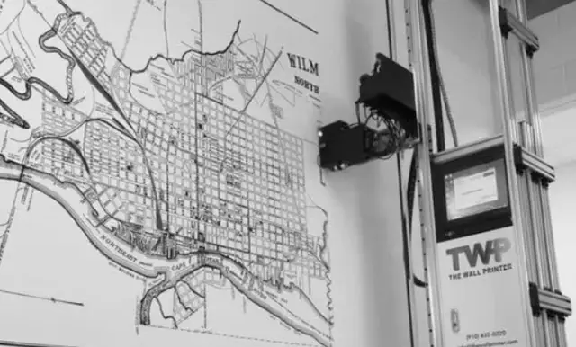 Commercial wall printer producing a custom city map mural on an interior wall