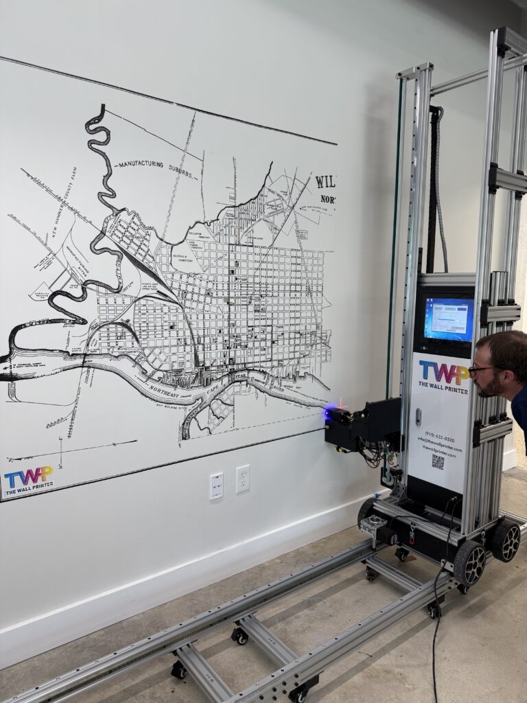 The Wall Printer printing a custom vintage city map mural directly onto an interior wall using commercial UV wall printing technology.