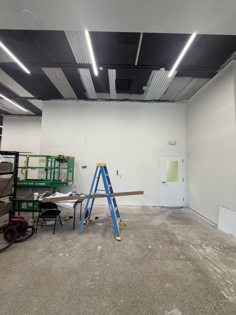 Blank white church lobby wall during construction at The Bridge Church before the For The One wall was printed