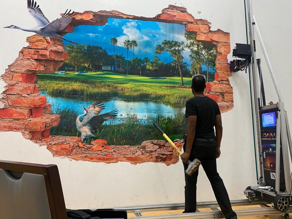 A golf course pond with herons printed as a break-through scene on an interior wall, with the vertical printer beside it