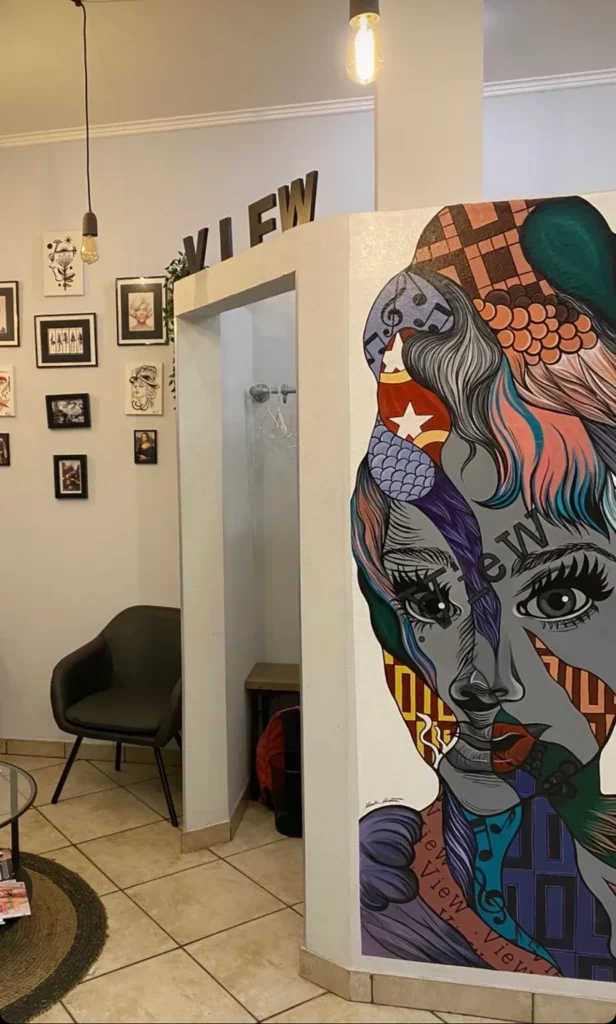 A pop art face printed on a salon wall beside the entry
