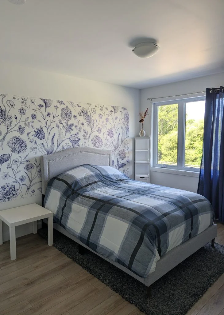 The same bedroom wall printed with a blue floral pattern