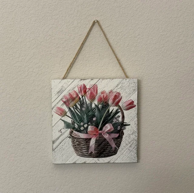 A basket of pink tulips printed on a hanging wood plank sign