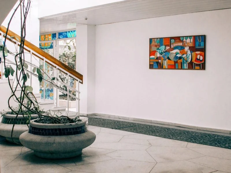 Abstract artwork printed on a white wall above a stairway landing