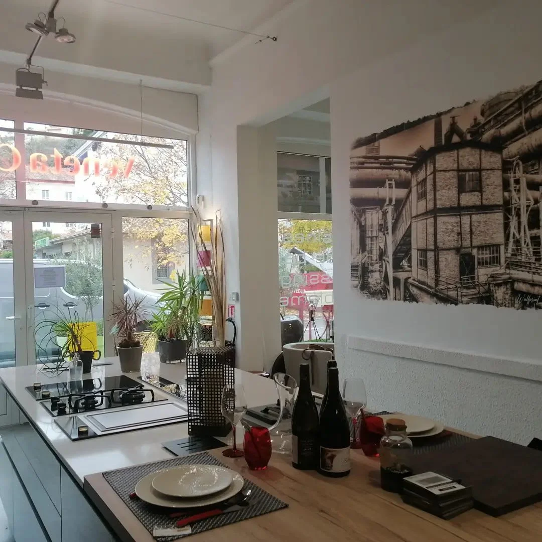 A black and white street scene printed across a wall beside a kitchen and dining table