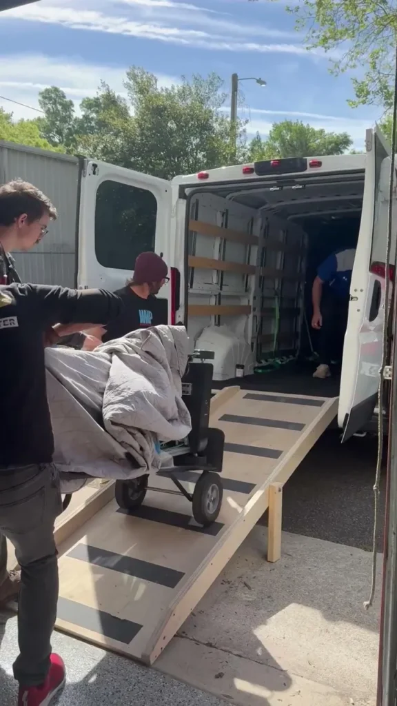 A wall printer rolled up a ramp into a work van