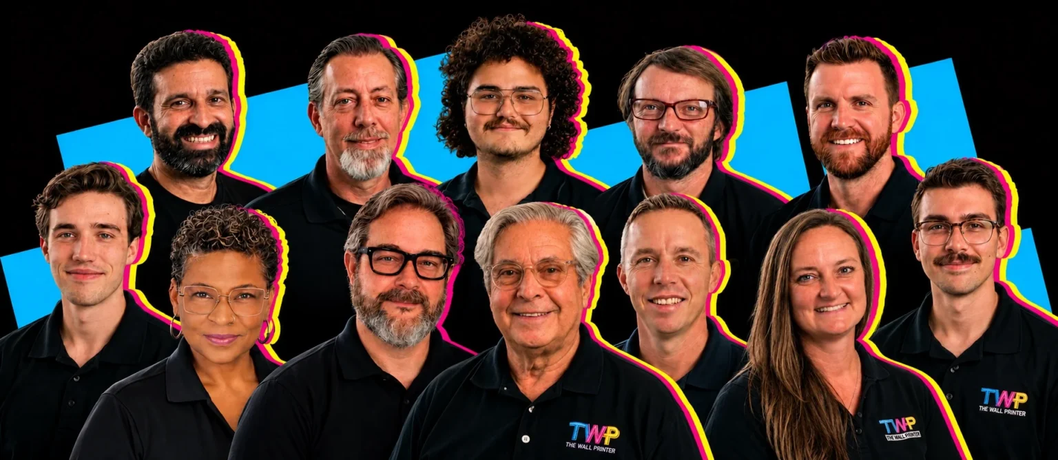The Wall Printer team in Wilmington, NC, twelve people in black TWP polo shirts
