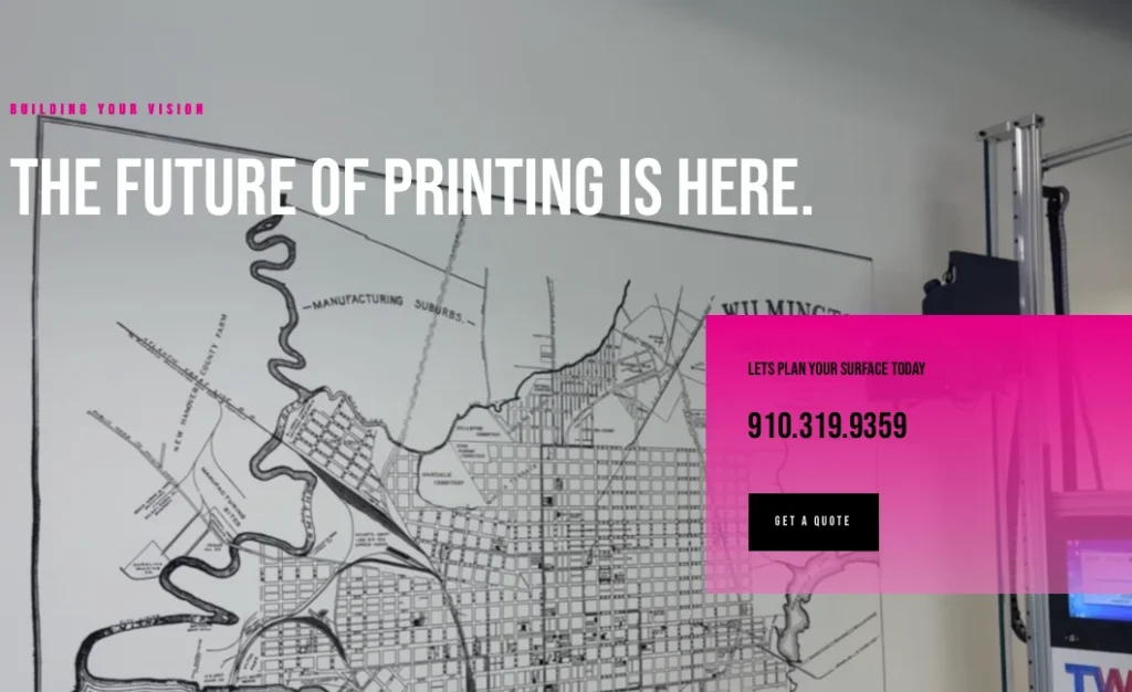 Wilmington Wall Printing website, showing a printed map of Wilmington on a wall beside the printer
