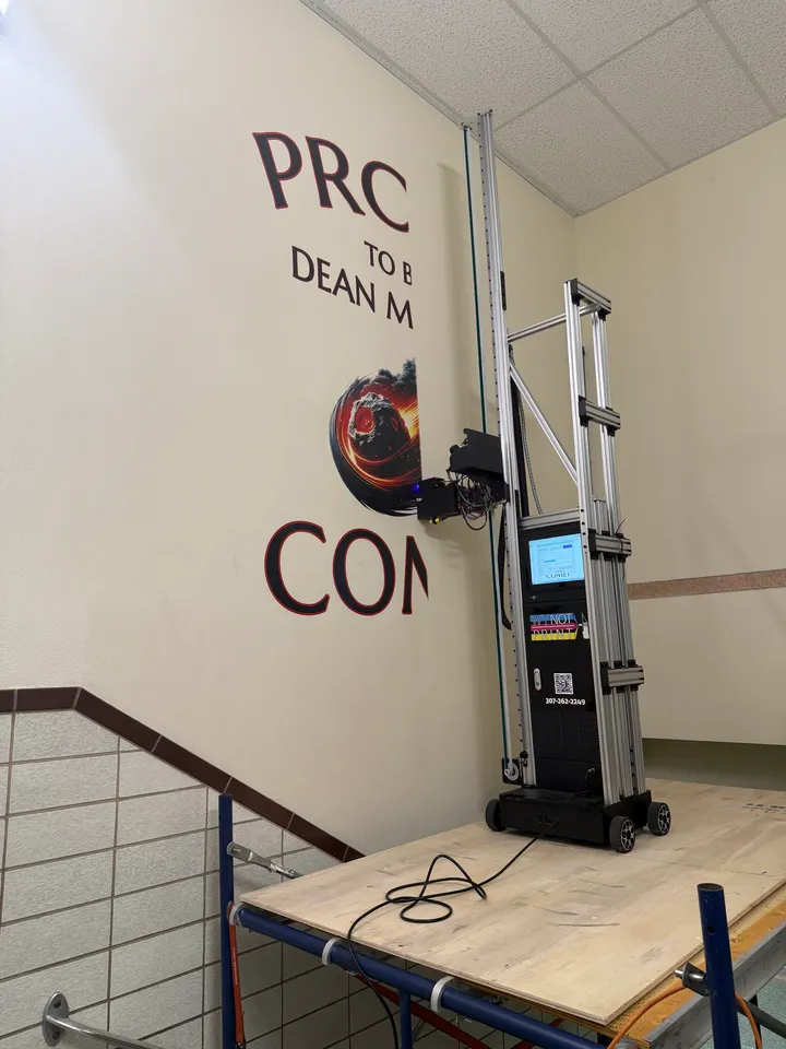 A Wy Not Print printer on scaffolding printing a school stairwell graphic
